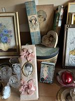 Overview of vintage boxes highlighting size, shape, and decorative details including portraits and ribbons.