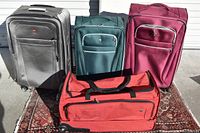 Full set of the four Swiss Army luggage pieces including three upright suitcases and one rolling duffle bag showing colors and general condition.
