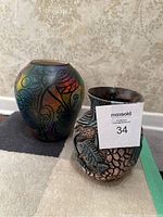 Front view of the two Wassi Art pottery vases, showing multicolor abstract vase and fish patterned vase.