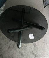 Top view of round smoked glass top and chrome tubular base