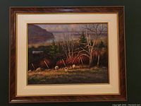 Framed oil painting showing full scene of sheep grazing in a field with trees and distant hill under cloudy sky.