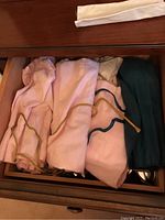 Drawer with cloth flatware keepers rolled and stored.