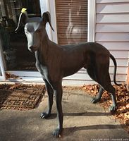 Full body front-right three-quarter view of statue on patio