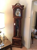 Straight-on full view of the clock showing case and base