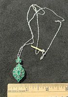 Full view of necklace and pendant with ruler for size reference
