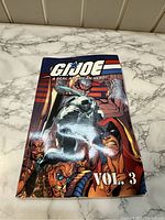 Front cover of G.I. Joe comic book Volume 3 with colorful characters shown and title.