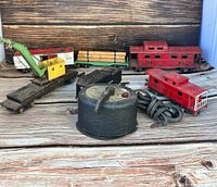 Front angled photo showing all train cars and controller on wood background
