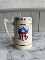 Front view of vintage cream ceramic stein with NFL shield logo and gold trim.