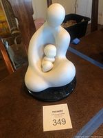 Full view of mother and child sculptures on black marble base