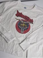 Close-up of the front graphic showing Judas Priest logo and design on the white waffle knit long sleeve crop top.