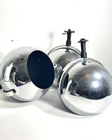 Three chrome spherical light shades grouped together showing polished finish and mounting hardware.