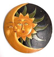 Front view of round wooden wall hanging depicting sun and crescent moon with painted details on black starry background.