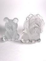 Front view of frosted glass bear and dog figurines showing detailed textured fur and facial features.