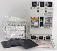 Front view of Fuji Electric BW50KAGU circuit breaker, showing labeled toggle switch and mounting accessories in packaging.
