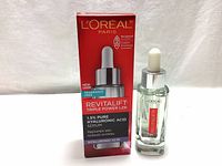 Photo of the front of the packaging box and the dropper bottle itself, showing the branding and product name.