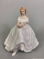 Front and side views of the Royal Doulton porcelain figurine Heather HN 2956, showing detailed white off-shoulder dress and hairstyle.