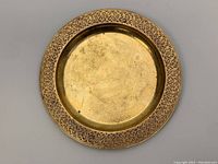 Full top-down view of the antique Tiffany Studios bronzed gold gilded etched plate, model #1737, showing the entire circular plate with its ornate etched rim and gold center.