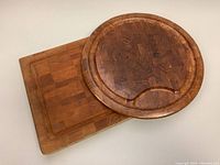 Rectangular and round wooden boards shown together to capture size and surface details.