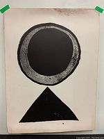 Full view of lithograph taped to wall, showing entire composition and edge wear.