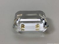 Top angled view showing the rectangular faceted crystal with internal gold hearts.