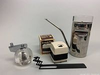 Full lot with stainless steel pitcher, Peugeot pepper mill, Crumb Vac in box, and crumb vac device removed from box