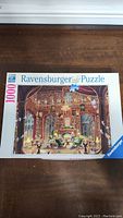 Box top showing full image and title 'Sanctuary Of Knowledge' by Ravensburger with 1000 pieces.