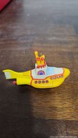 Front angle view of the Yellow Submarine Christmas ornament showing detailed paint and structure.