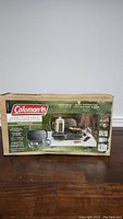 Full view of Coleman 2-burner propane stove box showing front with product image and brand.