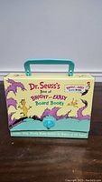 Closed box displaying Dr. Seuss's Box of Bright & Early Board Books with teal handle and colorful Dr. Seuss characters