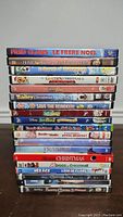 Photo showing a stack of 17 children's and family Christmas-themed DVDs with visible titles.