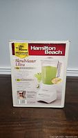 Full boxed view of the Hamilton Beach 12 speed blender model BlendMaster Ultra, showing the product name and main features.