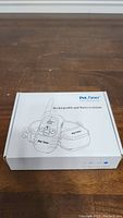 Closed box showing illustration and branding of the Petainer Dog Training Collar highlighting its rechargeable and water-resistant features