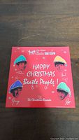 Red collector's box with Beatles members wearing Santa hats and Christmas-themed text on cover.
