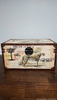 Front view of decorative chest showing cheetah and South Africa safari print with black metal latch