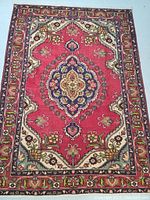 Full top-view of the rug showing overall pattern and red field with central medallion