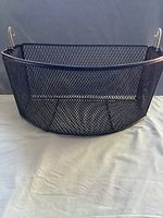 Front view of the black hard wire mesh basket for walker on a light background.