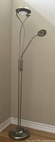Full view of the floor lamp showing its height, two light fixtures and satin chrome finish.