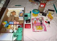 Full lot overview showing all vintage doll house furniture pieces, baby doll, toy stove and TV, and battery operated lamp packaging.