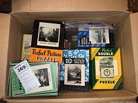 Photo of seven vintage puzzle boxes, mostly from Perfect Picture Puzzle brand, plus a plastic bag with loose puzzle pieces in a cardboard box.