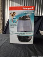 Front of box showing Honeywell Ultrasonic Cool Mist Humidifier image and key features: no filters required, ultra quiet operation, variable output settings, auto shut off when empty, 3.8L tank capacity.
