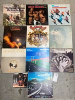 Photo showing all 10 vinyl albums laid out on a floor, titles visible.