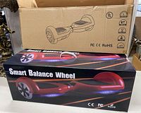 Photo of the boxed Smart Balance Wheel red hoverboard scooter showing the product image and branding.