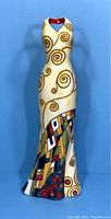 Full front view of the vase showing the dress form, the v-neck cut, and the cream base color with spiral designs.