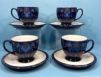 Four vintage Denby Baroque footed cups and saucers arranged in pairs, showing front and side views.