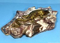 View showing the brass lizard figure on the patterned marble base.