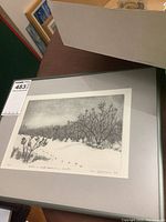 Framed etching displayed at an angle, showing entire print, grey mat, black frame