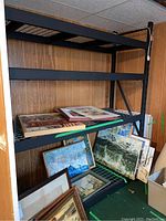 Overall view of the shelving unit with four wire racks and various items displayed on shelves