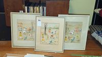 Group view of three framed coloured pencil illustrations by M.E. Crawford showing water-damaged mats and simple silver-tone frames