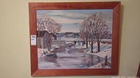 Framed winter river landscape artwork with snow and trees, visible signature of Fred Bartlett