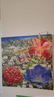 Front view of square canvas oil painting with vibrant floral scene.